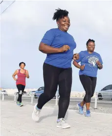  ??  ?? From left: Samantha Allen (background), Simone Smith, and Paulette Hendricks run along the Palisadoes strip on July 30.