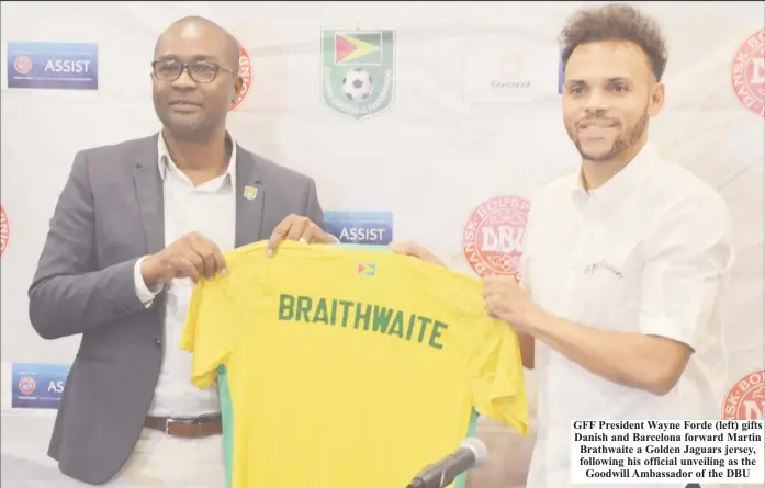  ?? ?? GFF President Wayne Forde (left) gifts Danish and Barcelona forward Martin Brathwaite a Golden Jaguars jersey, following his official unveiling as the Goodwill Ambassador of the DBU