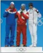  ?? MORRY GASH — THE ASSOCIATED PRESS ?? Medalists in the men’s giant slalom, from left, Norway’s Henrik Kristoffer­sen, silver, Austria’s Marcel Hirscher, gold, and France’s Alexis Pinturault, bronze, pose during their medals ceremony at the 2018 Winter Olympics in Pyeongchan­g, South Korea,...