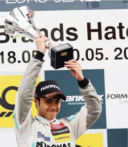  ??  ?? Top of the world: Jazeman Jaafar holding his trophy after winning the F3 Euro Series at Brands Hatch in England on Sunday.