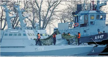  ??  ?? A Ukrainian gunboat and tug in the Crimean port of Kerch after being seized by the Russians