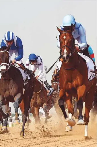 ?? Virendra Saklani/Gulf News ?? ■ Heavy Metal, ridden by Ryan Moore and trained by Sandeep Jadhav, leads the pack to win the Godolphin Mile, the opening race of the Dubai World Cup at Meydan yesterday.