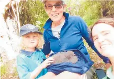  ?? Photo / Supplied ?? Former Matakohe-Limestone Island ranger Cathy Mitchell, centre, with Emma Craig, right and Craig’s son Quincy Carpenter with the chick before it fledged.