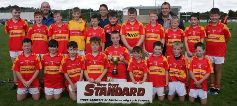  ??  ?? The title-winning Horeswood footballer­s with their delighted mentors.