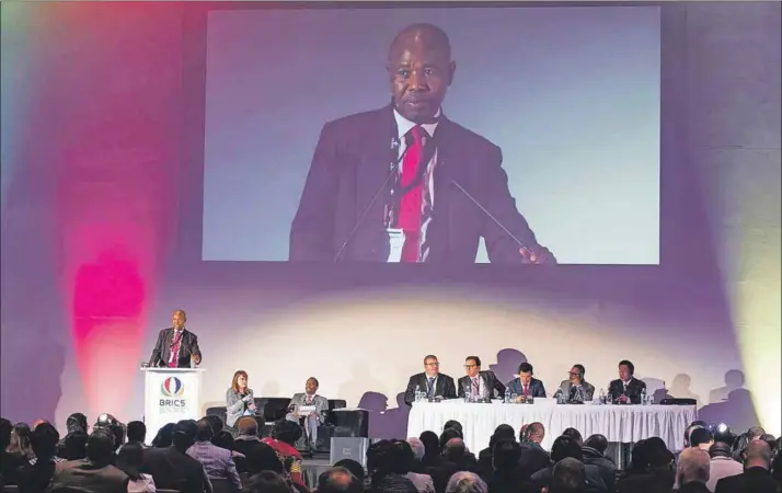  ?? ?? Standing: Mvuso Notyesi welcomed delegates to the fifth Brazil, Russia, India, China and South Africa Legal Forum conference in 2018, when he was the Law Society of South Africa co-chair.