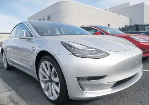  ?? AP ?? Unsold 2018 Model 3 Long Range versions sit on a Tesla dealer’s lot in the south Denver suburb of Littleton, Colorado in this April 15, 2018 file photo.