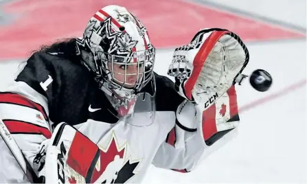  ?? JASON KRYK/THE CANADIAN PRESS ?? Canada goaltender Shannon Szabados makes a glove save during the Women’s World Hockey Championsh­ip, on March 31. Szabados is one of 28 players invited to try out for the 2018 Olympic women’s hockey team currently toiling in an 18-day boot camp in...