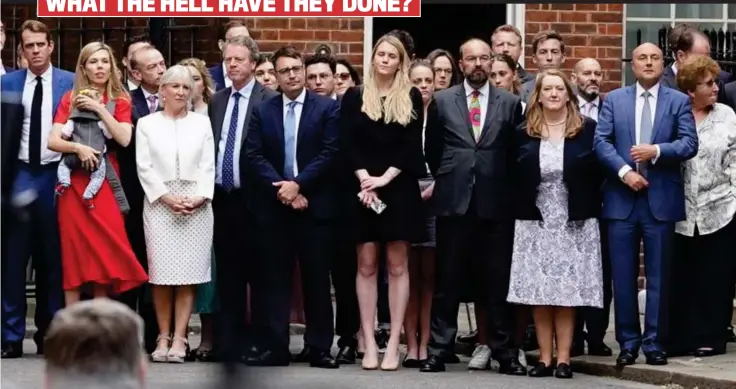  ?? ?? Solemn support: Among those listening yesterday was, far left, Carrie Johnson with baby Romy. Next to her was Nadine Dorries. Above right: Jacob Rees-Mogg