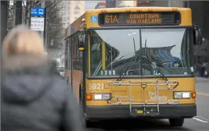  ?? Post-Gazette ?? A Port Authority bus rolls to a stop on Liberty Avenue.