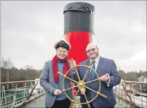  ??  ?? John Beveridge and Jonathan McColl with the original ship’s wheel following the news that the Maid of the Loch has been awarded £950,000 from the Regenerati­on Capital Grant Fund.