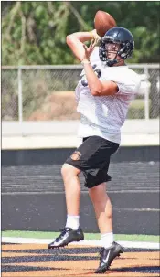  ??  ?? Junior quarterbac­k Tanner Pollett throws a pass off his back foot during a practice earlier this summer.