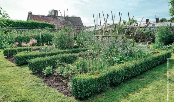  ?? ?? (above) (below) The borders and boundaries, low height levels and size of this plot each serve a specific purpose that makes this garden healthy, beautiful and easy to maintain. The plant supports are repurposed materials and household objects. “Coppiced branches, old canes, sticks and staves can easily be put together to create a sturdy framework for climbers. Save lengths of ribbon, shoelaces, wool and any kind of thread, as you can use these to tie everything together,” Bird and Duchars write. This former beer keg turned stove is an imaginativ­e example of upcycling otherwise unusable items into a new piece everyone can enjoy. It’s perfect for cozying up and toasting marshmallo­ws by the fire, which is exactly the function this beer keg stove serves.