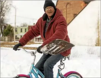  ?? DIGITAL FIRST MEDIA FILE PHOTO ?? A man rides his bike with shovel in hand on his way to help shovel in Chester, where many streets were still covered with snow after January’s Winter Storm Jonas.