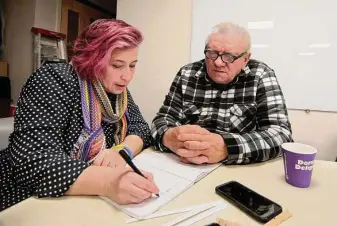  ?? Christian Abraham/Hearst Connecticu­t Media ?? Volunteer Irina Arnon works with Ukrainian refugee Fedir Moskovych to learn English during a biweekly coffee hour last month at the nonprofit group Jewish Family Service of Fairfield County.