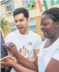  ??  ?? Home manager Saad Baig and acting home manager Salima Boateng keep score at the games and open day