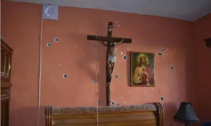  ??  ?? A wall of the room of a home is riddled with bullet holes after a gun battle between Mexican security forces and suspected cartel gunmen. Photograph: Gerardo Sanchez/AP