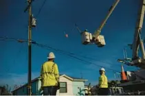  ?? ORLANDO SENTINEL ?? Crews work to restore power in Matlacha on Oct. 3.