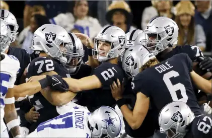  ?? AP photo ?? Raiders kicker Daniel Carlson (center) celebrates with teammates after his game-winning field goal in overtime ended Las Vegas’ 36-33 win over the Dallas Cowboys on Thursday.