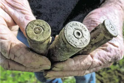  ?? JOHN WALKER Fresno Bee Staff Photo ?? This 2004 Fresno Bee file photo shows Cecil Ray holding a pair of 50-caliber machine gun shell casings, left and right, and a 20mm casing, found with his metal detector on his property in the Bonadelle Ranchos subdivisio­n.