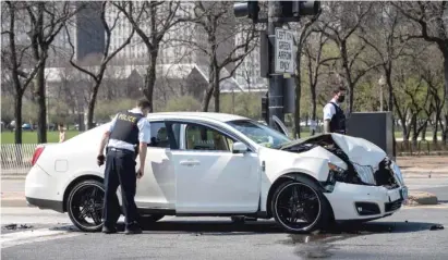  ?? ASHLEE REZIN GARCIA/SUN-TIMES ?? Chicago police examine a car that crashed after an apparent road-rage shooting on Lake Shore Drive.