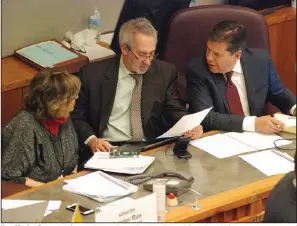  ?? (AP/Morgan Lee) ?? New Mexico Reps. Joy Garratt (from left) and Daymon Ely and Sen. Joseph Cervantes, sponsors of the red-flag legislatio­n, confer Friday during a floor debate in the state Senate.