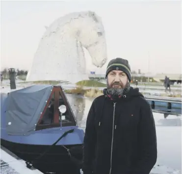  ??  ?? 0 Robert Fettes, 54, who lives on the canal, used his barge to break up ice and help rescue the dog