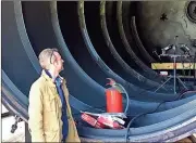  ?? Doug Walker / Rome News-Tribune ?? Keep Rome Floyd Beautiful volunteer Thomas Kislat peers inside the Green Carbon tire recycling reactor on North Avenue on Tuesday. The reactor can reduce a 63-inch mining tire to 580 gallons of oil, 3,500 pounds of carbon black and 1,500 pounds of...