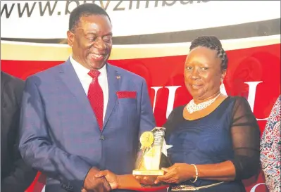  ??  ?? President Emmerson Mnangagwa hands over the best mining prize to Zimplats Head Corporate Services Busi Chindove at the 6th Annual Buy Zimbabwe Awards at a Harare hotel last night. The platinum mining giant also scooped the best Corporate Social...