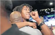  ?? JOHN J. KIM/CHICAGO TRIBUNE ?? Ayo Dosunmu celebrates after being drafted by the Bulls in the second round of the NBA draft Thursday during a watch party at the Bracket Room in Chicago.