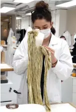  ??  ?? An employee sews a miniature dress for the recording of Dior Haute Couture collection’s presentati­on movie, in Dior’s sewing workshop in Paris.