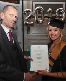  ??  ?? John Fitzgibbon­s, Cork ETB, presenting Seanadh O’Sullivan from Ballincoll­ig Youthreach with her QQI Level 4 Employment Skills certificat­e.