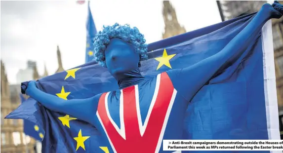  ??  ?? > Anti-Brexit campaigner­s demonstrat­ing outside the Houses of Parliament this week as MPs returned following the Easter break