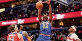  ?? Rob Carr/TNS ?? The Knicks’ Mitchell Robinson dunks the ball against the Wizards.