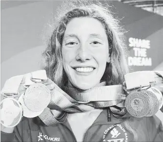  ?? CANADIAN PRESS FILE PHOTO ?? Canada’s Taylor Ruck holds up her eight swimming medals at the Commonweal­th Games in Gold Coast, Australia, on April 10.