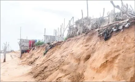  ?? YANICK FOLLY/AFP ?? A picture taken in Lome, on June 2, shows the effect of the erosion near huts belonging to a fishermen village near at the site of the constructi­on of the new port.