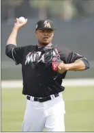  ?? Associated Press photo ?? Miami Marlins starting pitcher Edinson Volquez throws during a spring training baseball workout in Jupiter, Fla. last month.