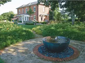  ??  ?? TOP Soft cushions of Nepeta
racemosa ‘Walker’s Low’ and the violet flowers of Geranium
‘Rozanne’ surround the bowl-shaped water feature. ABOVE A series of paths meander from the terrace to several points of interest, making the garden seem larger....