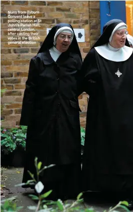  ??  ?? Nuns from Tyburn Convent leave a polling station at St John’s Parish Hall, central London, after casting their votes in the British general election