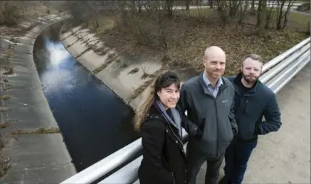  ?? MATHEW MCCARTHY, RECORD STAFF ?? Tina Malone-Wright, Brandon Sloan and Adam Clark of the City of Kitchener’s planning department stand next to the Schneider Creek culvert.