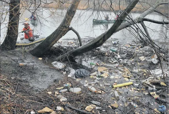  ??  ?? Teams of litter-pickers using canoes clear plastic waste from the River Aire; such pollution is now commonplac­e across Yorkshire and must be stopped, says Phil Penfold.