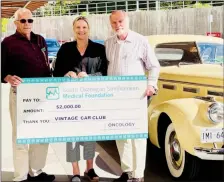  ?? ?? Dave Doman (left) and John Wyndcliff from the South Okanagan Vintage Car Club present a $2,000 donation to Sally Ginter, CEO of the South Okanagan Similkamee­n Medical Foundation.