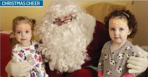  ??  ?? Lily Roche and Scarlet Monahan visiting Santa Claus at the ‘Christmas Cheer’ event at South Bray Resource Centre.