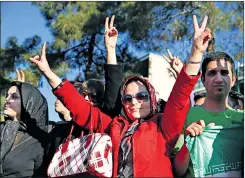  ?? AP ?? Iranians flash the victory sign after the nuclear talks in Lausanne, Switzerlan­d