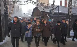  ?? (Agency Gazeta/Kuba Ociepa/Reuters) ?? SURVIVORS WALK in the former Nazi concentrat­ion and exterminat­ion camp Auschwitz-Birkenau.