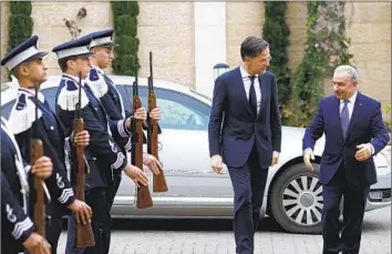  ?? Mohammed Torokman Pool Photo ?? OUTGOING Palestinia­n Authority Prime Minister Mohammad Shtayyeh, right, meets with Dutch counterpar­t Mark Rutte. The U.S., which envisions the authority governing postwar Gaza, said it welcomes reforms.