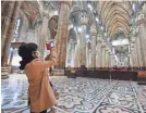  ?? AP ?? A tourist wearing a face mask takes pictures inside the Duomo gothic cathedral in Milan on March 2.