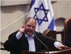  ?? Reuters; EPA ?? Top, a woman is embraced by a man carrying a rifle at the Mount of Olives in East Jerusalem; above, Israeli MP Ofer Cassif speaks at the Knesset