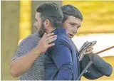  ?? PHOTO/JOHN MINCHILLO] ?? Bryson DeChambeau hugs Matthew Wolff (blue shirt) after winning the U.S. Open at Winged Foot on Sunday in Mamaroneck, N.Y. [AP