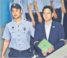  ??  ?? Lee arrives for his trial at the Seoul Central District Court. — Reuters photo