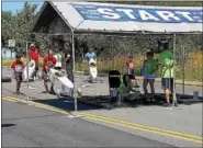  ??  ?? Drivers set up at the starting line just before running the track Saturday at the Pottstown Soap Box Derby. Drivers ranging in age from 7 to 21 took part in the derby’s Stock, Superstock and Masters divisions.